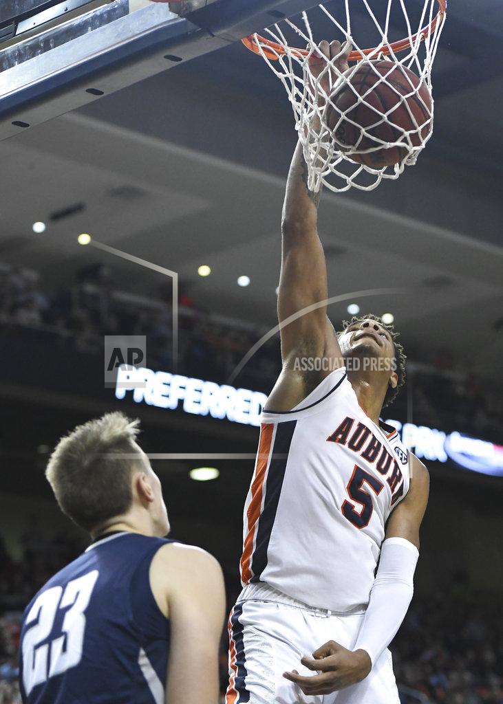Julie Bennett Auburn forward Chuma Okeke (5) dunks over North Florida forward Carter Hendricksen (23) during the second half of an NCAA college basketball game Saturday, Dec. 29, 2018, in Auburn, Ala. (AP Photo/Julie Bennett)