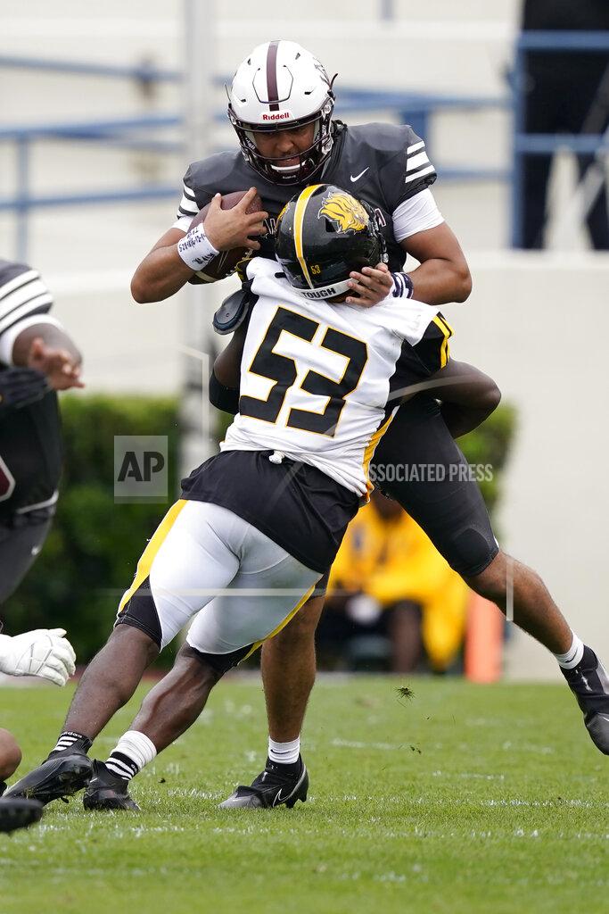 Rogelio V. Solis Alabama A&M quarterback Aqeel Glass (4) is sacked by Arkansas-Pine Bluff linebacker Isaac Peppers (53) during the second half of the Southwestern Athletic Conference Championship NCAA college football game, Saturday, May 1, 2021, in Jackson, Miss. Alabama A&M won 40-33. (AP Photo/Rogelio V. Solis)