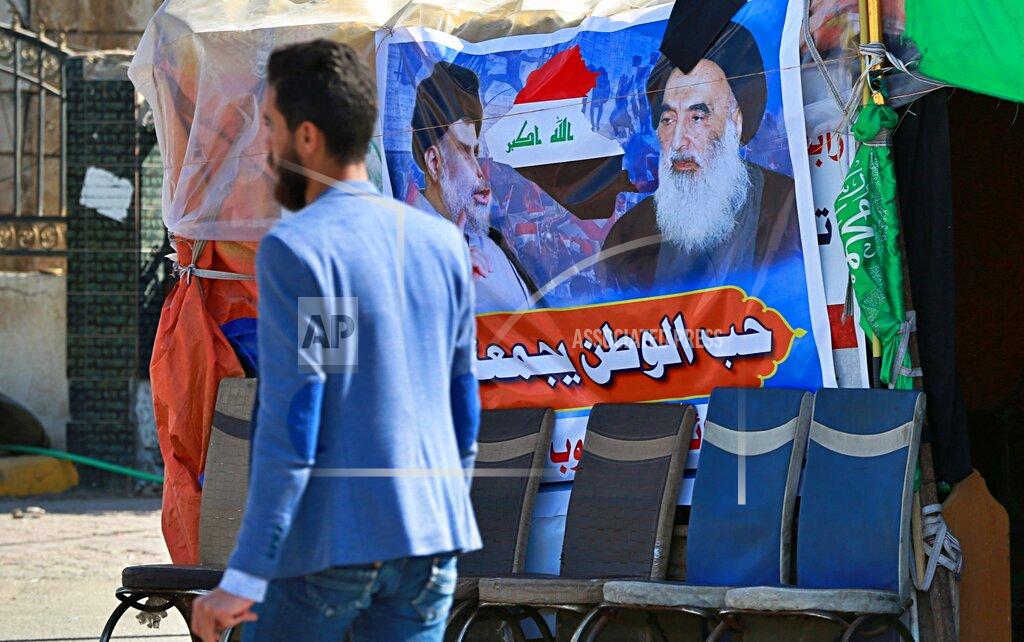Hadi Mizban FILE - In this Sunday, Feb. 2, 2020 photo, a poster of Shiite spiritual leader Grand Ayatollah Ali al-Sistani, right, and Arabic that reads, "the love of the country bonds us together," is seen in Najaf, Iraq. Iraq’s top Catholic official said Thursday, Jan. 28, 2021 that a deadly suicide bombing in Baghdad hasn’t thwarted Pope Francis’ plans to visit, and he confirmed the pontiff would meet with the country’s top Shiite cleric, Ali al-Sistani, in a significant highlight of the first-ever papal trip to Iraq. The Chaldean patriarch, Cardinal Louis Raphael Sako, provided the first details of Francis’ March 5-8 itinerary during a virtual press conference hosted by the French bishops' conference. (AP Photo/Hadi Mizban, File)