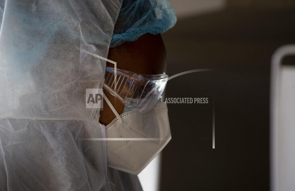 Denis Farrell FILE - In this Tuesday, June 22, 2021 file photo, a healthcare worker prepares to test patients for COVID-19 at the Lancet Laboratories in Johannesburg. Africa is facing a devastating resurgence of COVID-19 infections whose peak will surpass that of earlier waves as the continent's countries struggle to vaccinate even a small percentage of the population, top health officials said Thursday June 24, 2021. (AP Photo/Denis Farrell, File)