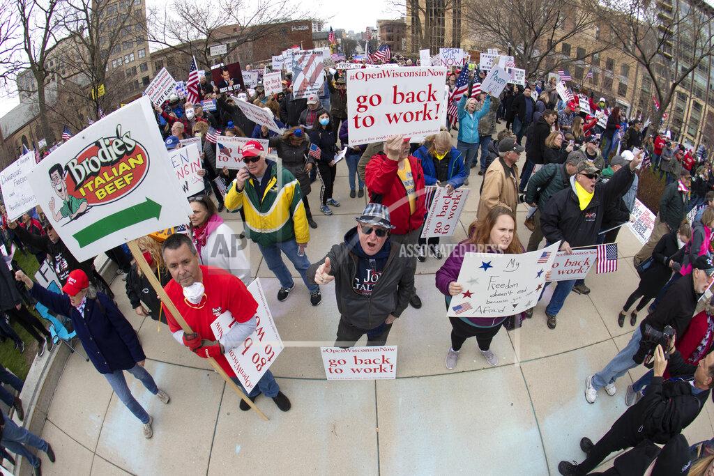 Mark Hoffman FILE - In this April 24, 2020, file photo, people demonstrate against Gov. Tony Evers' restrictions on daily life due to the coronavirus pandemic at the Capitol in Madison, Wis. Wisconsin has been the battleground for political proxy wars for nearly a decade, the backdrop for bruising feuds over labor unions, executive power, redistricting and President Donald Trump. Now, six months before a presidential election, the state is on fire again — some might say still. With a divided state government and a polarized electorate, Wisconsin has emerged as the hot bed of partisan fighting over the coronavirus, including how to slow its spread, restart the seized economy, vote amid a pandemic and judge Trump's leadership. (Mark Hoffman/Milwaukee Journal-Sentinel via AP, File)