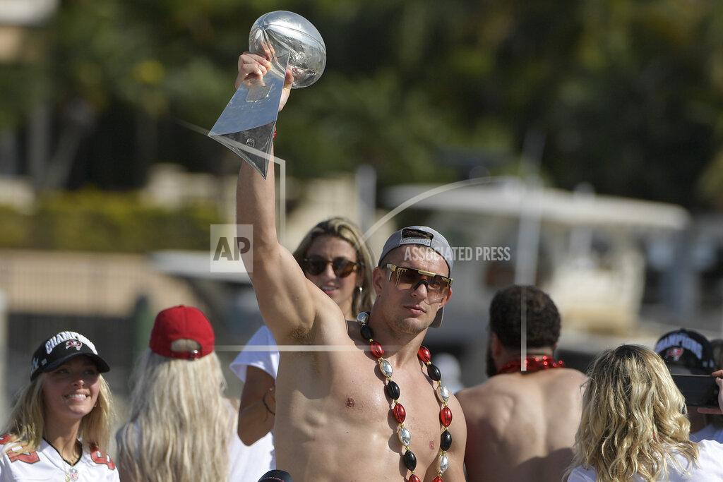 Phelan Ebenhack Tampa Bay Buccaneers NFL football tight end Rob Gronkowski holds up the Vince Lombardi trophy during a celebration of their Super Bowl 55 victory over the Kansas City Chiefs with a boat parade in Tampa, Fla., Wednesday, Feb. 10, 2021. (AP Photo/Phelan Ebenhack)