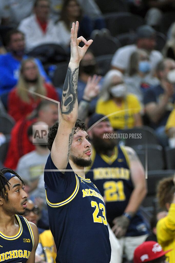 David Becker Michigan forward Brandon Johns Jr. (23) reacts after a 3-point basket against UNLV during the first half of an NCAA college basketball game Friday, Nov. 19, 2021, in Las Vegas. (AP Photo/David Becker)