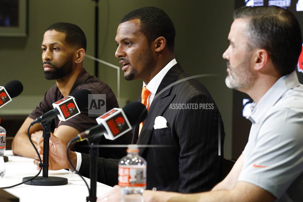 Ron Schwane Cleveland Browns new quarterback Deshaun Watson, center, speaks during a news conference at the NFL football team's training facility as general manager Andrew Berry, left, and head coach Kevin Stefanski listen, Friday, March 25, 2022, in Berea, Ohio. (AP Photo/Ron Schwane)