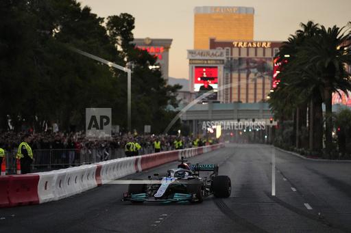 FILE - George Russell drives during a demonstration along the Las Vegas Strip at a launch party for the Formula One Las Vegas Grand Prix, Saturday, Nov. 5, 2022, in Las Vegas. There&rsquo;s no such thing as a flawless first-year event, so go ahead and accept there will be bumps and bruises in Formula One&rsquo;s $500 million Las Vegas Grand Prix. (AP Photo/John Locher, File)