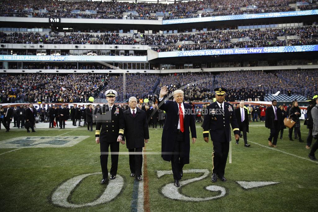 Matt Rourke President Donald Trump, center right, accompanied by Secretary of Defense Jim Mattis, center left, waves as they walk on the field before of an NCAA college football game between Army and Navy, Saturday, Dec. 8, 2018, in Philadelphia. (AP Photo/Matt Rourke)