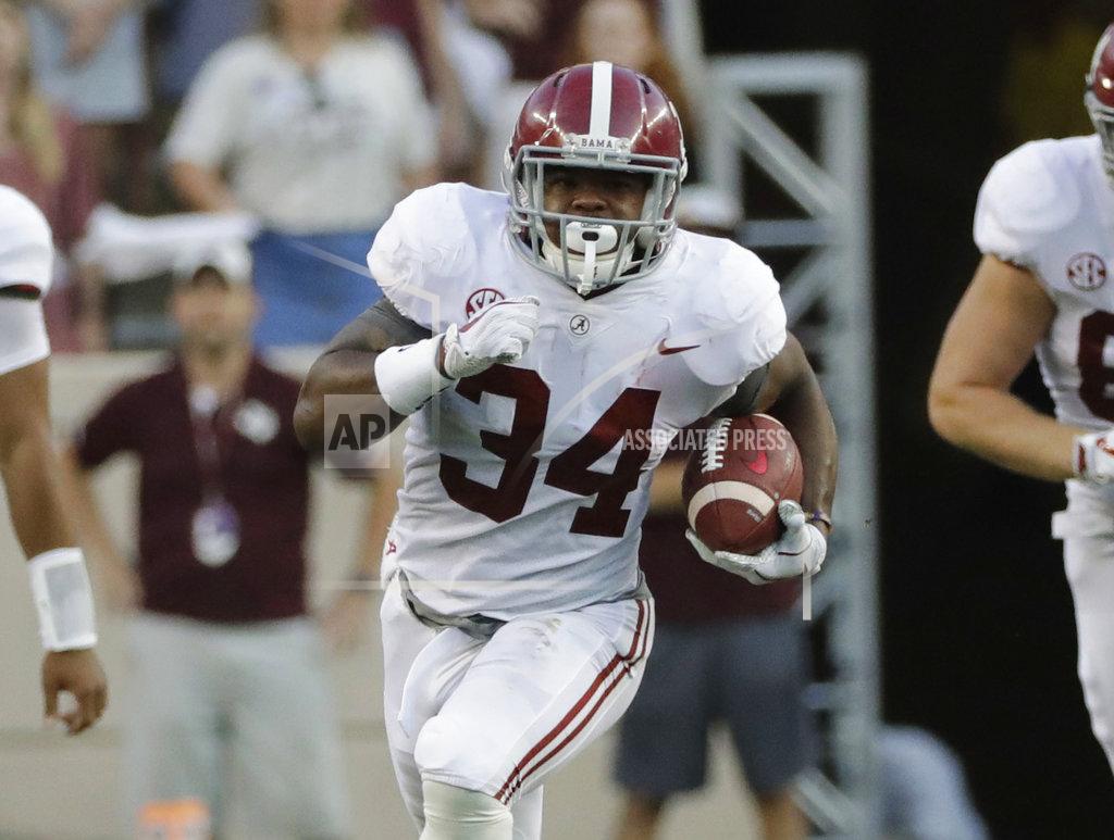 FILE - In this Oct. 7, 2017, file photo, Alabama's Damien Harris (34) rushes for a 75-yard touchdown against Texas A&M during the first quarter of an NCAA college football game, in College Station, Texas. Harris bucked the trend of Alabama's recent starting tailbacks, who follow up big seasons with an early departure for the NFL. Instead, Harris opted to stick around for his senior season and has a chance to become the first Crimson Tide rusher with three 1,000-yard seasons. (AP Photo/David J. Phillip, File)