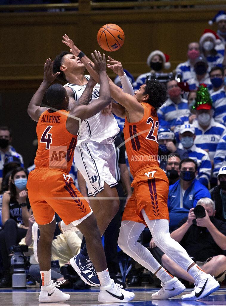 Ben Mckeown Duke's Paolo Banchero (5) loses the ball while Virginia Tech's Nahiem Alleyne (4) and Keve Aluma (22) defend during the first half of an NCAA college basketball game in Durham, N.C., Wednesday, Dec. 22, 2021. (AP Photo/Ben McKeown)