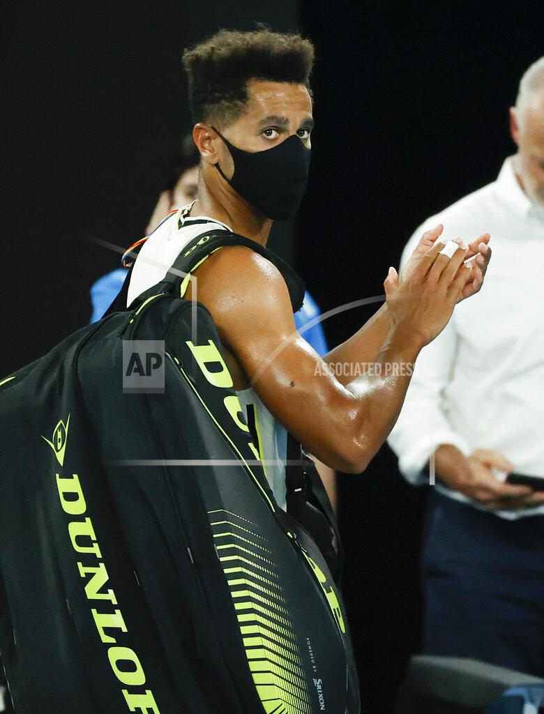 Rick Rycroft United States' Michael Mmoh walks from Rod Laver Arena following his second round loss to Spain's Rafael Nadal at the Australian Open tennis championship in Melbourne, Australia, Thursday, Feb. 11, 2021.(AP Photo/Rick Rycroft)
