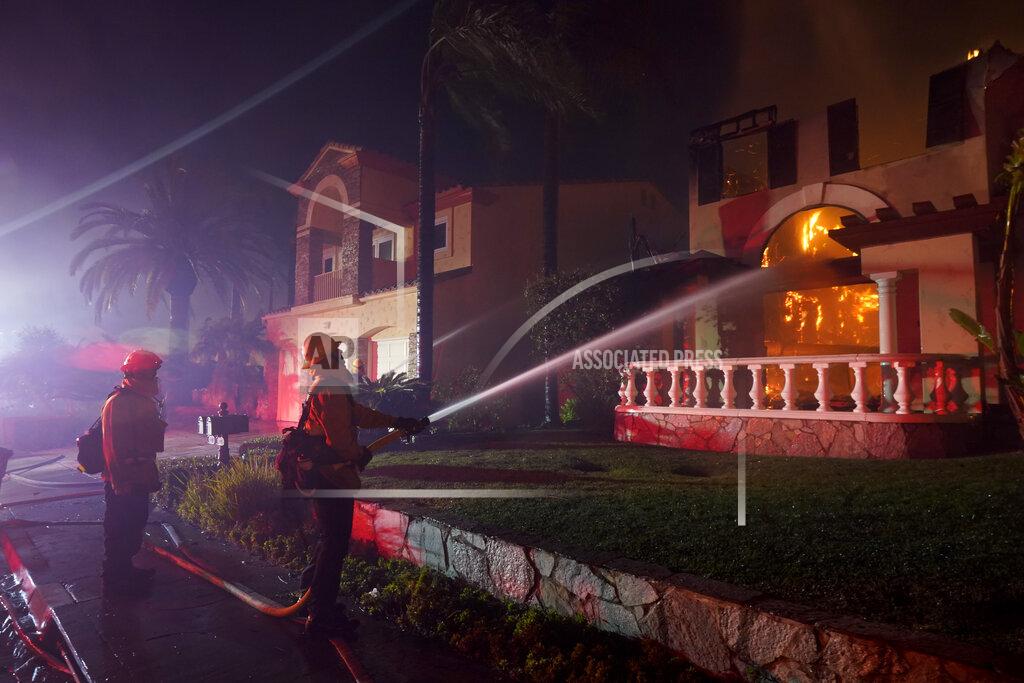 Marcio J. Sanchez Firefighters work to put out a structure burning during a wildfire Wednesday, May 11, 2022, in Laguna Niguel, Calif. (AP Photo/Marcio J. Sanchez)