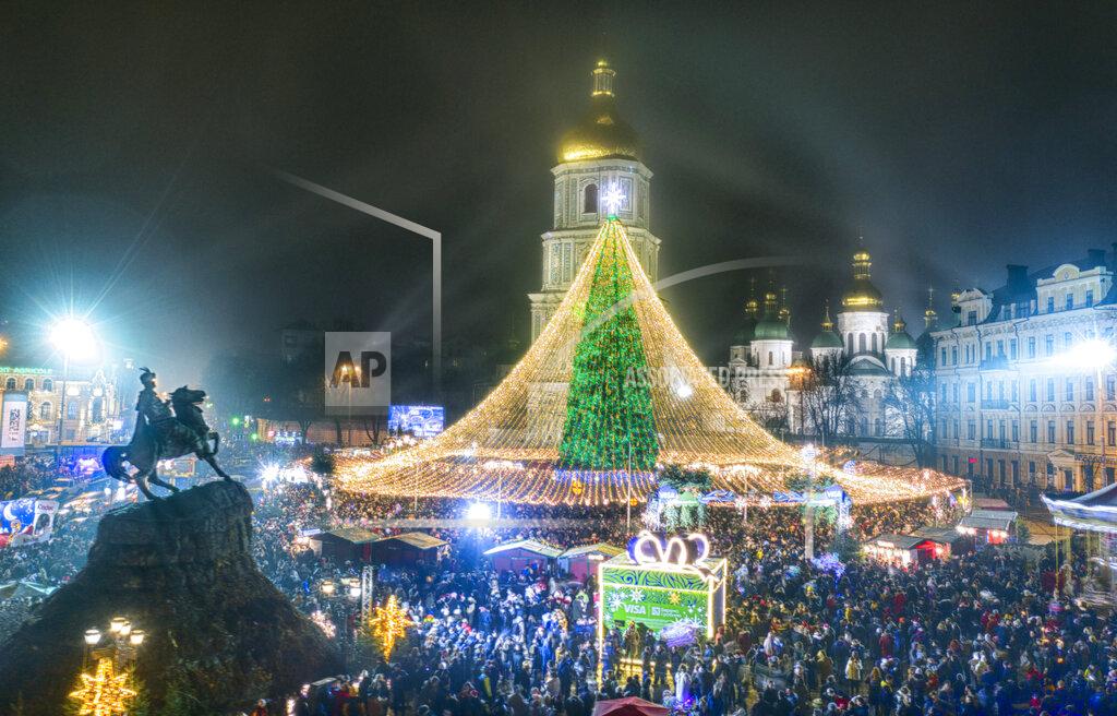 Efrem Lukatsky Crowds of people celebrate the New Year around the Christmas tree with the St. Sofia Cathedral in the background in Kyiv, Ukraine, early Friday, Jan. 1, 2021. Despite of COVID-19 quarantine restrictions, a lot of Ukrainians enjoy outdoor New Year events, often ignoring protective measures. (AP Photo/Efrem Lukatsky)