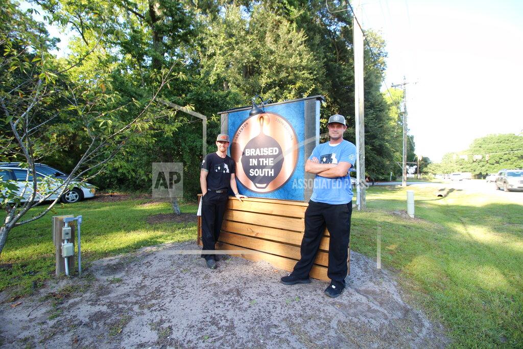 Uncredited This photo provided by Hannah Albert on Sept. 23, 2020 shows Steve Klatt, left, and Brandon Lapp, owners of Braised in the South, a Johns Island, S.C, restaurant and food truck business that is having trouble finding workers during the pandemic. Many small businesses find hiring more difficult because many would-be staffers fear contracting COVID-19 on the job or would prefer to live off unemployment benefits. (Hannah Albert via AP)
