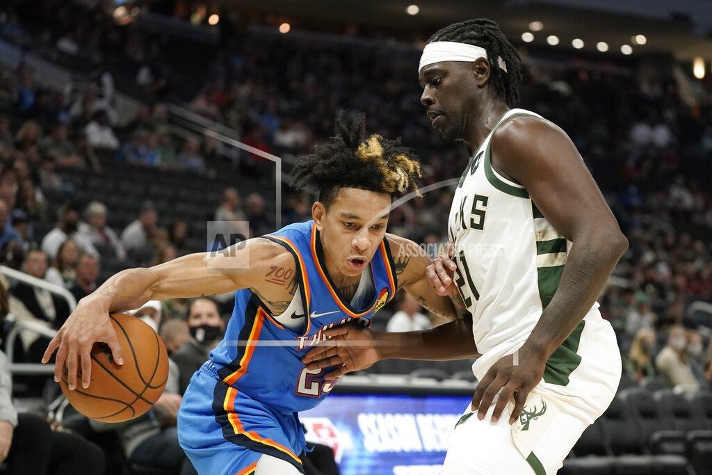 Morry Gash Oklahoma City Thunder's Tre Mann tries to get past Milwaukee Bucks' Jrue Holiday during the first half of an NBA preseason basketball game Sunday, Oct. 10, 2021, in Milwaukee. (AP Photo/Morry Gash)