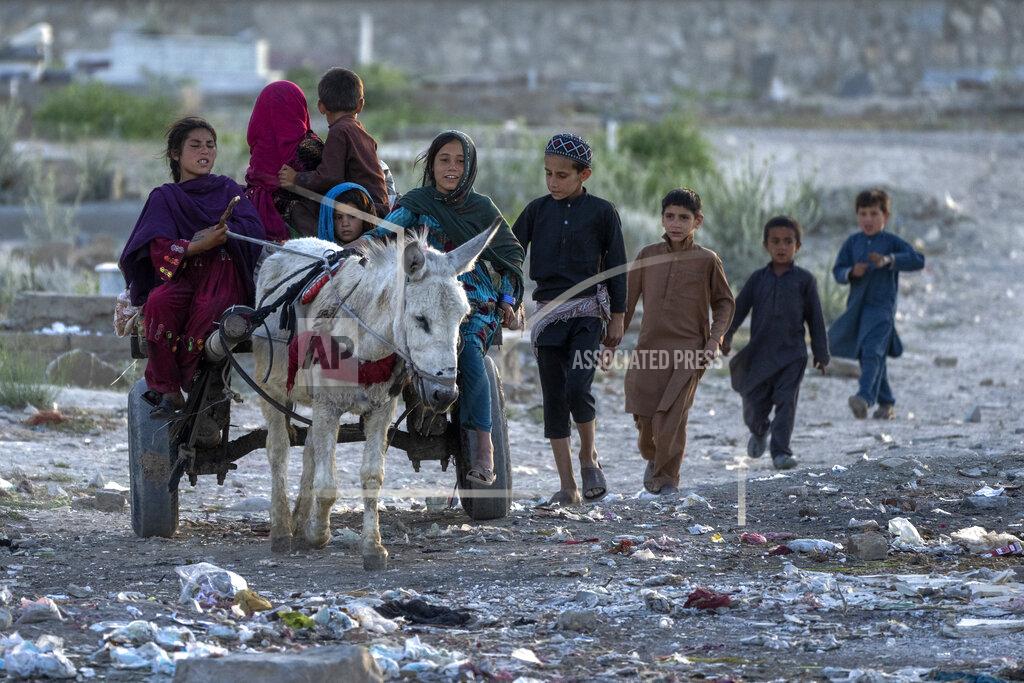 Ebrahim Noroozi Afghan children return home from work in one of Kabul's poor neighbourhoods in Kabul, Afghanistan, Friday, May 20, 2022. Some 1.1 million Afghan children under the age of five will face malnutrition by the end of the year. , as hospitals wards are already packed with sick children . (AP Photo/Ebrahim Noroozi)