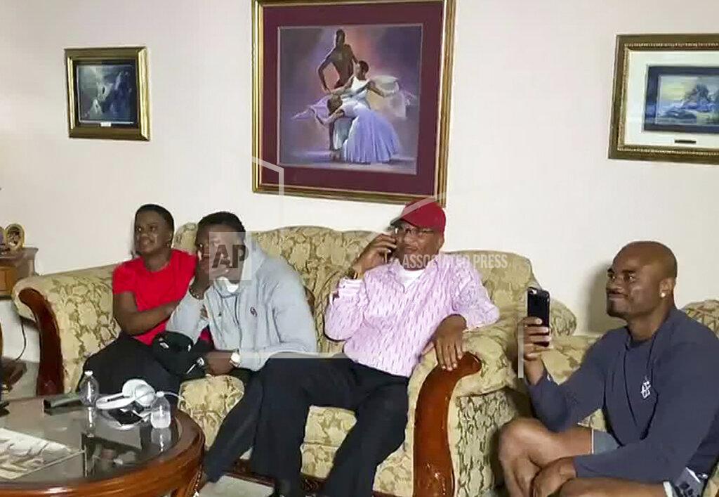Uncredited In this still image from video provided by the NFL, Kenneth Murray, second from left, watches the NFL football draft Thursday, April 23, 2020, in Missouri City, Texas. Murray was chosen by the Los Angeles Chargers. (NFL via AP)