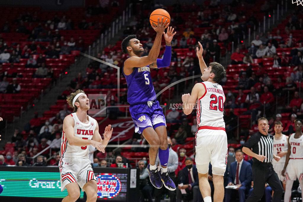 Rick Bowmer Washington guard Jamal Bey (5) goes to the basket as Utah guard Lazar Stefanovic (20) defends during the first half of an NCAA college basketball game Thursday, Jan. 6, 2022, in Salt Lake City. (AP Photo/Rick Bowmer)