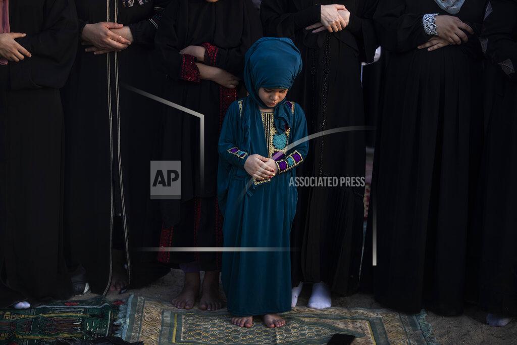 Khalil Hamra Palestinian Muslims attend the prayer of the first day of Eid al-Adha in Gaza City, Tuesday, July. 20, 2021. (AP Photo/Khalil Hamra)