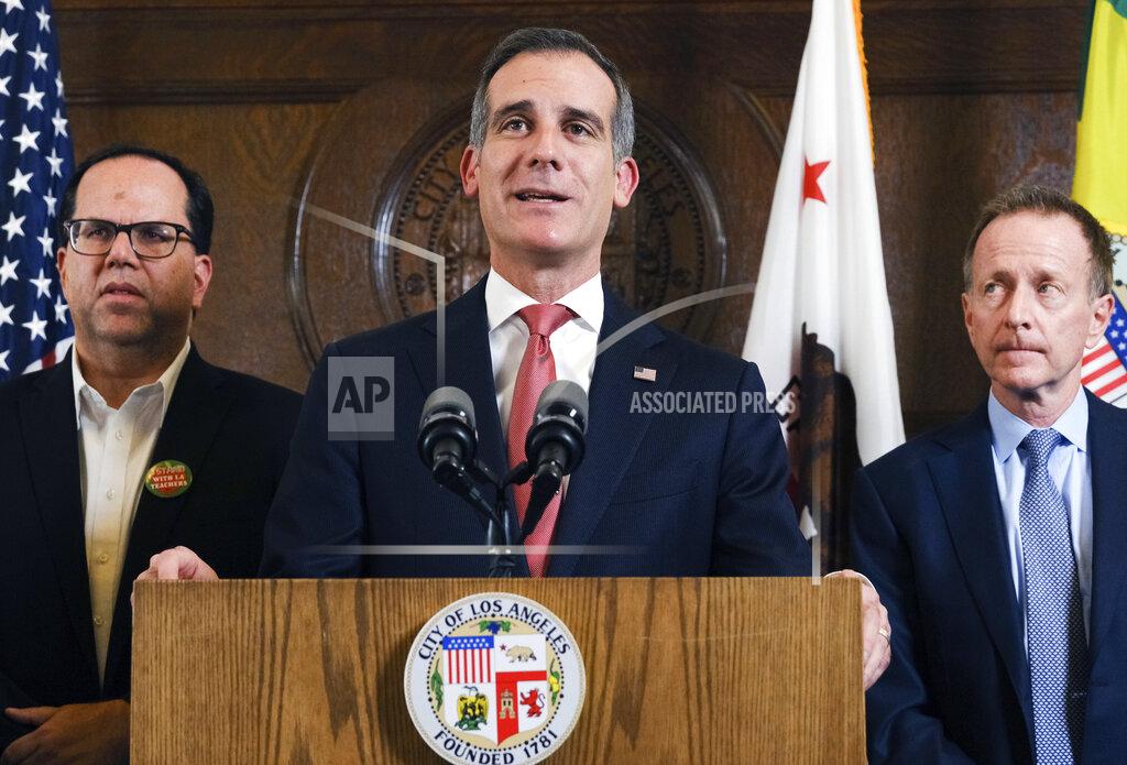 Richard Vogel FILE - In this Jan. 22, 2019 file photo Los Angeles Mayor Eric Garcetti, center flanked by Austin Beutner, Superintendent of the Los Angeles Unified School District, right, and United Teachers Los Angeles, Union President Alex Caputo-Pearl, left, during a news conference at City Hall downtown Los Angeles. Students in California classrooms can sit 3 feet apart instead of 6 under new guidelines adopted by the state as school officials figure out how to reopen campuses closed for a year during the coronavirus pandemic. (AP Photo/Richard Vogel, File)
