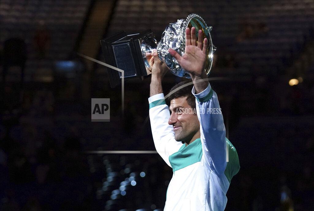 Mark Dadswell Serbia's Novak Djokovic holds the Norman Brookes Challenge Cup aloft after defeating Russia's Daniil Medvedev in the men's singles final at the Australian Open tennis championship in Melbourne, Australia, Sunday, Feb. 21, 2021.(AP Photo/Mark Dadswell)