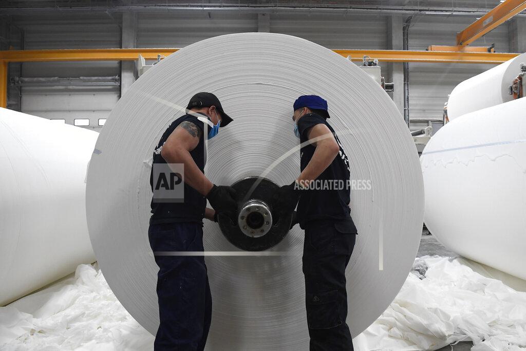 Tamas Kovacs Employees work at a plant of Vajda-Papir Ltd in Budapest, Hungary, Friday, April 17, 2020. The Hungarian-owned company is able to provide its partners with enormous production capacity in all product categories as its annual base paper production far exceeds domestic needs, therefore Hungary can even be self-sufficient in these products despite the increased demand due to the ongoing pandemic of the COVID-19 disease caused by the SARS-CoV-2 coronavirus. (Tamas Kovacs/MTI via AP)