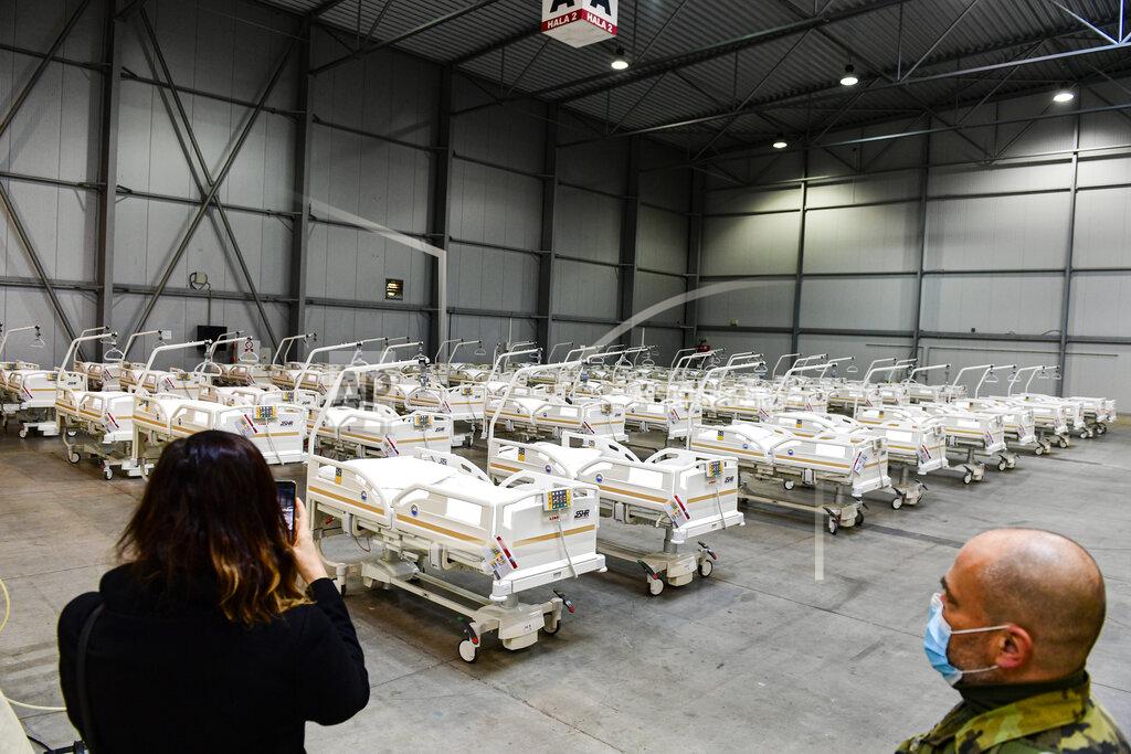Roman Vondrous A journalist takes a picture of beds prepared in a field hospital, which will function as a backup device for patients with coronavirus, in the Letnany neighbourhood at the Prague outskirts, Czech Republic, Thursday, Oct. 22, 2020. (AP Photo via CTK/Roman Vondrous) SLOVAKIA OUT