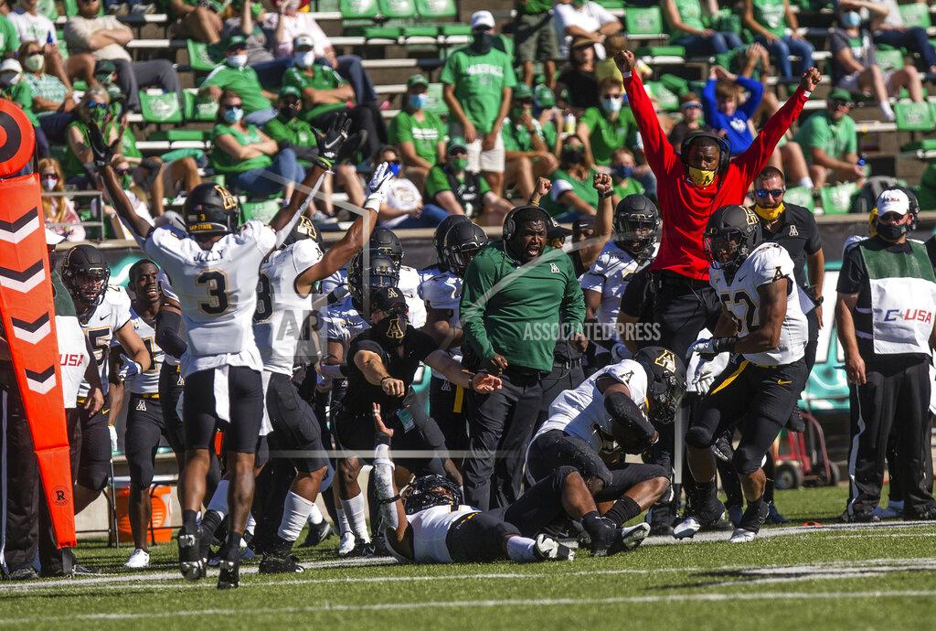 Sholten Singer Appalachian State players celebrate an interception by safety E.J. Jackson during an NCAA college football game against Marshall Saturday, Sept. 19, 2020, in Huntington, W.Va. (Sholten Singer/The Herald-Dispatch via AP)