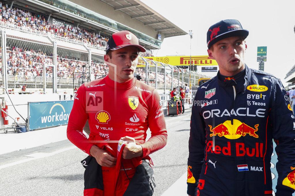 Joan Monfort Ferrari driver Charles Leclerc of Monaco, left, pole position, is flanked by second fastest time Red Bull driver Max Verstappen of the Netherlands after the qualifying session at the Barcelona Catalunya racetrack in Montmelo, Spain, Saturday, May 21, 2022. The Formula One race will be held on Sunday. (AP Photo/Joan Monfort)