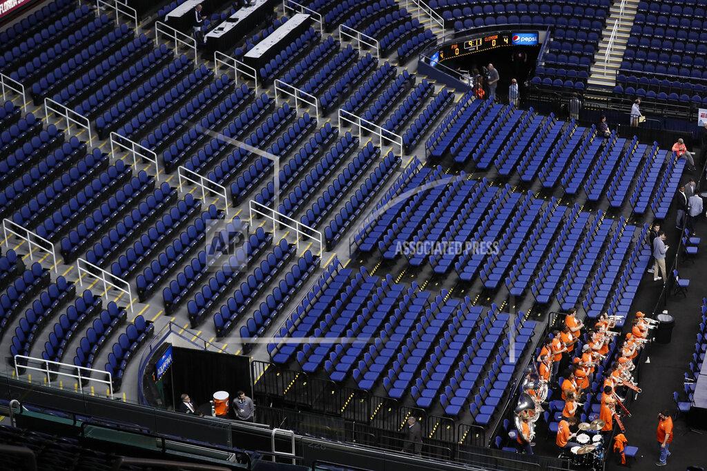 Gerry Broome The Clemson band sits in a mostly empty Greensboro Coliseum after the NCAA college basketball games were cancelled at the Atlantic Coast Conference tournament in Greensboro, N.C., Thursday, March 12, 2020. The biggest conferences in college sports all canceled their basketball tournaments because of the new coronavirus, seemingly putting the NCAA Tournament in doubt.(AP Photo/Gerry Broome)
