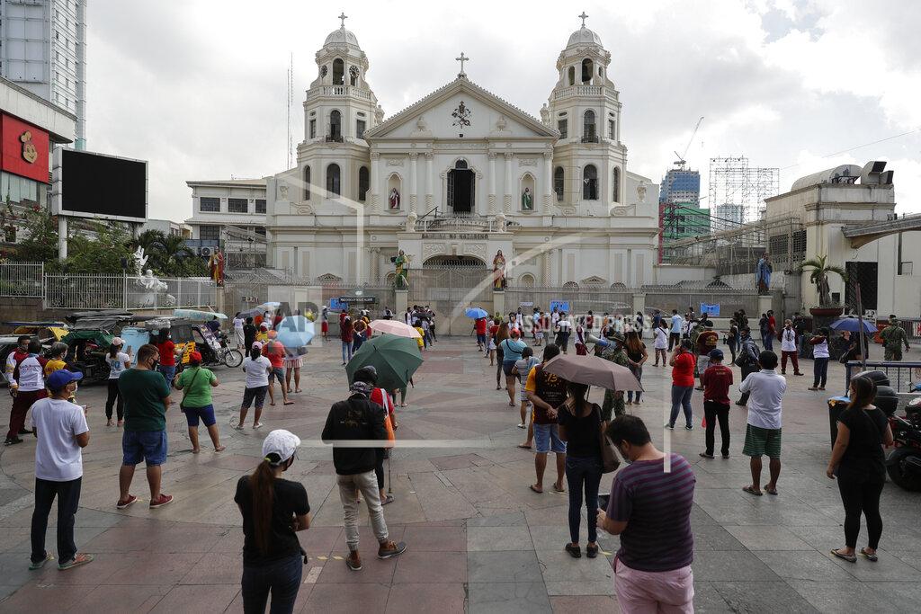Aaron Favila Devotees wait for their turn to go inside the Minor Basilica of the Black Nazarene, popularly known as Quiapo church as social distancing measure are placed to prevent the spread of the new coronavirus as it slowly reopens its doors in downtown Manila, Philippines on Friday, June 5, 2020. President Rodrigo Duterte has expressed relief that "Filipinos are really law-abiding" and that the Philippines was not going through riots like America which would make coronavirus quarantine enforcement formidable. (AP Photo/Aaron Favila)