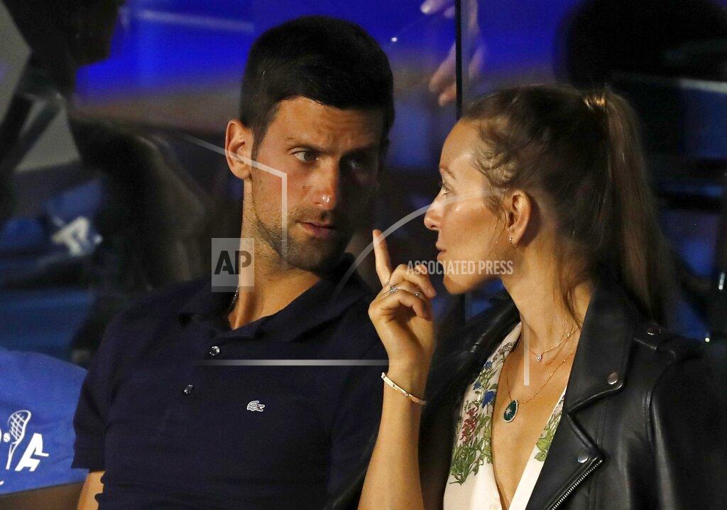 Darko Vojinovic FILE - In this Sunday, June 14, 2020 file photo Serbia's Novak Djokovic, left, speaks with his wife Jelena during a final match of the Adria Tour charity tournament, between Austria's Dominic Thiem and Serbia's Filip Krajinovic, in Belgrade, Serbia. Novak Djokovic has tested positive for the coronavirus after taking part in a tennis exhibition series he organized in Serbia and Croatia. The top-ranked Serb is the fourth player to test positive for the virus after first playing in Belgrade and then again last weekend in Zadar, Croatia. His wife also tested positive. (AP Photo/Darko Vojinovic, File)
