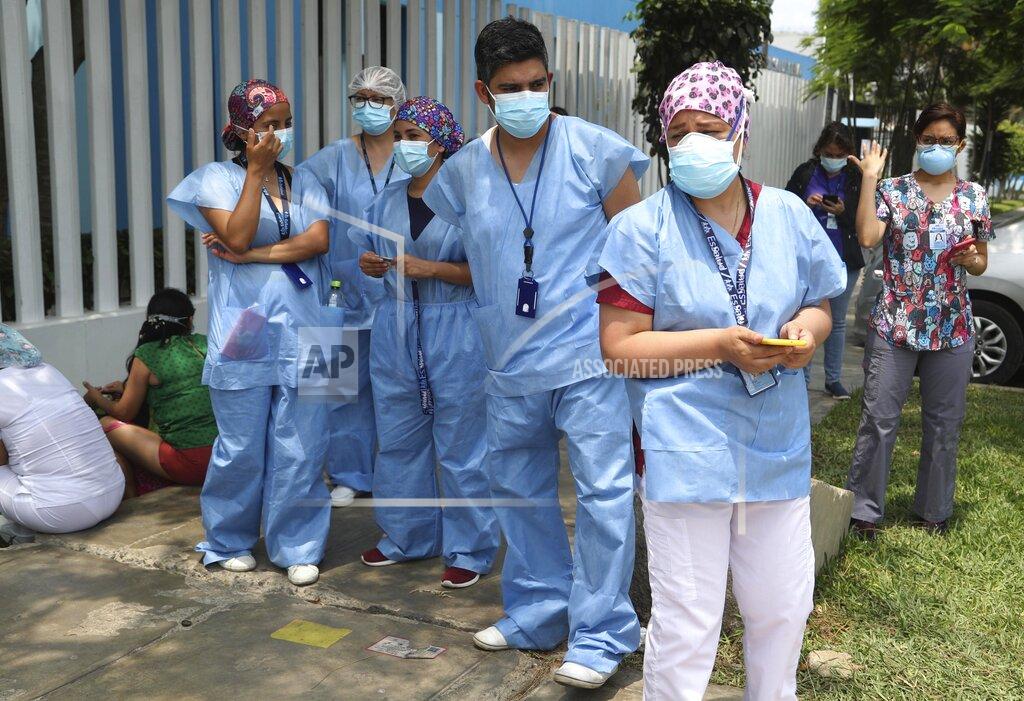 Martin Mejia Medical workers who say they work directly with COVID-19 patients stand outside the public Rebagliati Hospital where they say they work, as other health workers get shots of China's Sinopharm vaccine during a priority vaccination campaign inside the facility in Lima, Peru, Wednesday, Feb. 10, 2021. The group complains they are not on the list of medical workers to be vaccinated and that some people getting shots do not work directly with COVID-19 patients. (AP Photo/Martin Mejia)
