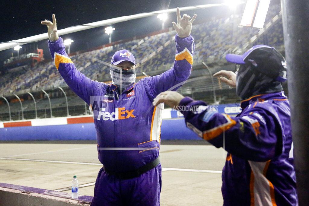 Brynn Anderson Members of Denny Hamlin's crew celebrate after Hamlin won the rain-shortened NASCAR Cup Series auto race Wednesday, May 20, 2020, in Darlington, S.C. (AP Photo/Brynn Anderson)