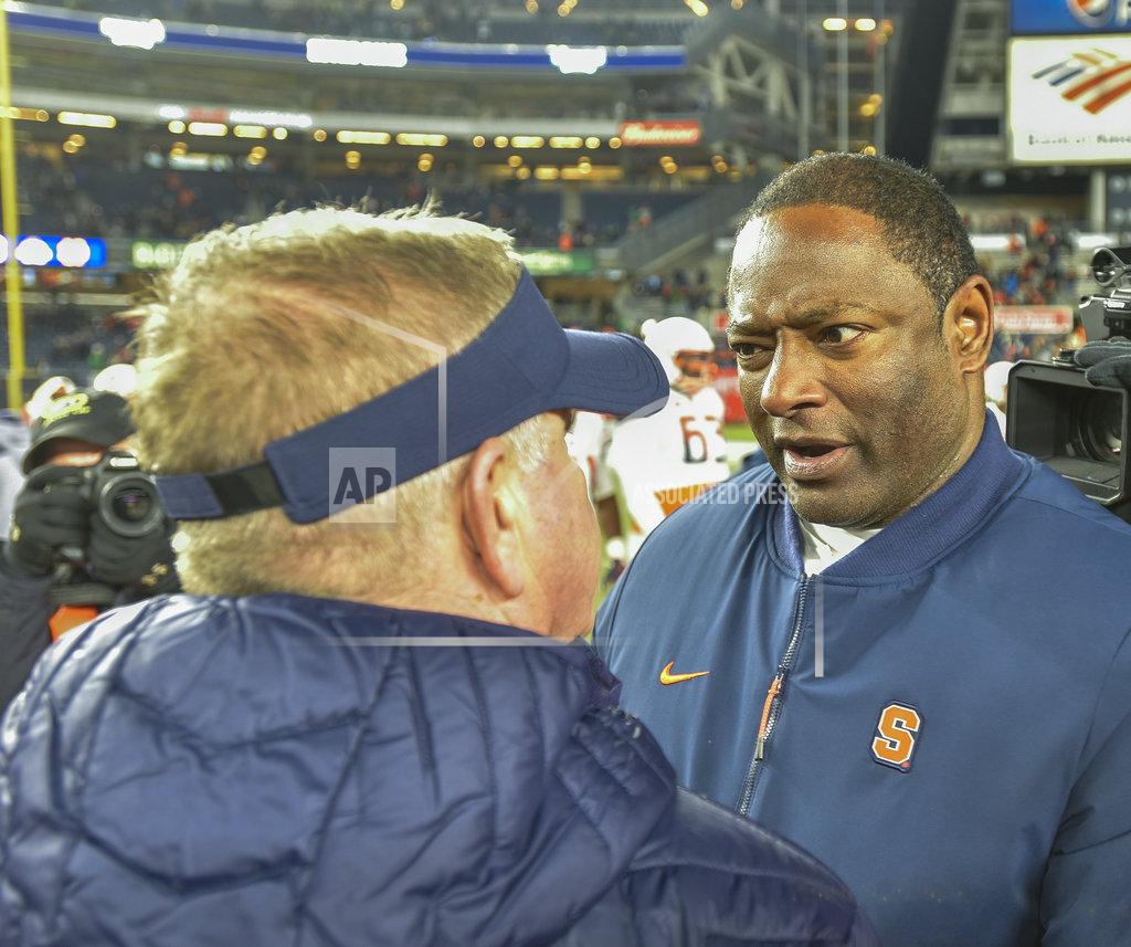 Howard Simmons Syracuse head coach Dino Babers, right, greets Notre Dame head coach Brian Kelly after an NCAA college football game, Saturday, Nov. 17, 2018, at Yankee Stadium in New York. (AP Photo/Howard Simmons)