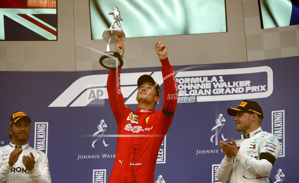 Francisco Seco Ferrari driver Charles Leclerc of Monaco, center, lifts the trophy after finishing first in the Belgian Formula One Grand Prix in Spa-Francorchamps, Belgium, Sunday, Sept. 1, 2019. Mercedes driver Lewis Hamilton of Britain, left, placed second and Mercedes driver Valtteri Bottas of Finland, right, placed third. (AP Photo/Francisco Seco)
