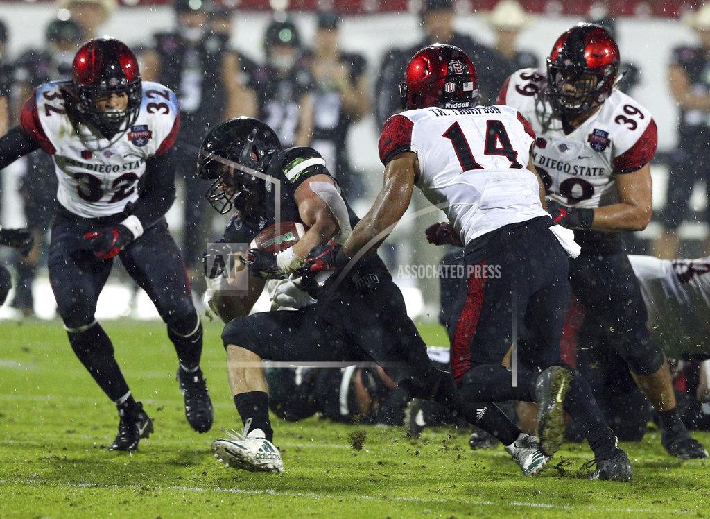 Richard W. Rodriguez Ohio running back A.J. Ouellette (45) tries to evade a tackle by San Diego State safety Tariq Thompson (14) in the second half of the Frisco Bowl NCAA college football game, Wednesday, Dec. 19, 2018, in Frisco, Texas. (AP Photo/Richard W. Rodriguez)