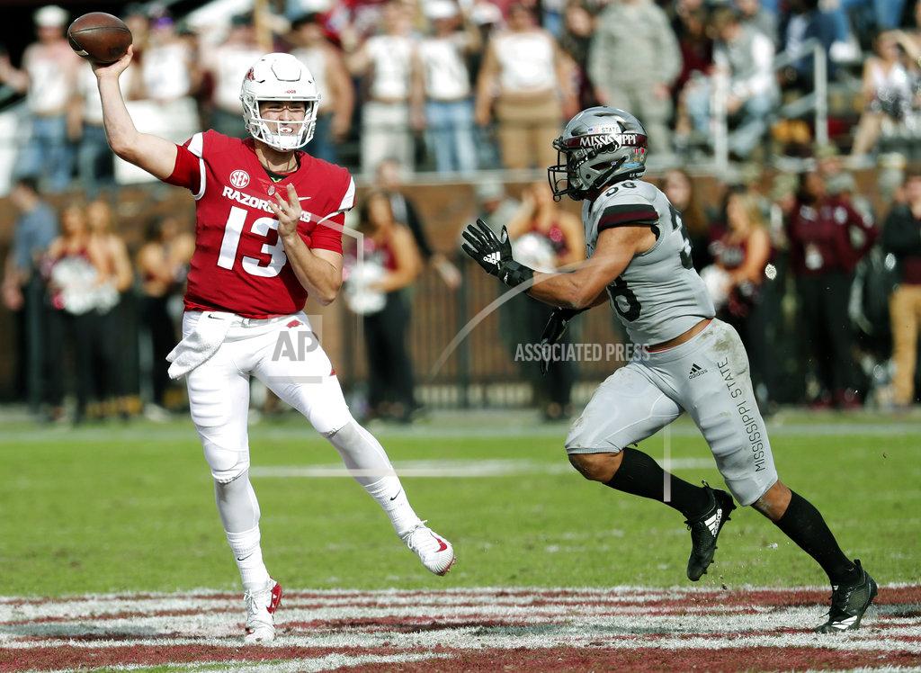 Rogelio V. Solis Arkansas quarterback Connor Noland (13) passes as he is being rushed by Mississippi State safety Johnathan Abram (38) during the second half of an NCAA college football game in Starkville, Miss., Saturday, Nov. 17, 2018. Mississippi State won 52-6. (AP Photo/Rogelio V. Solis)