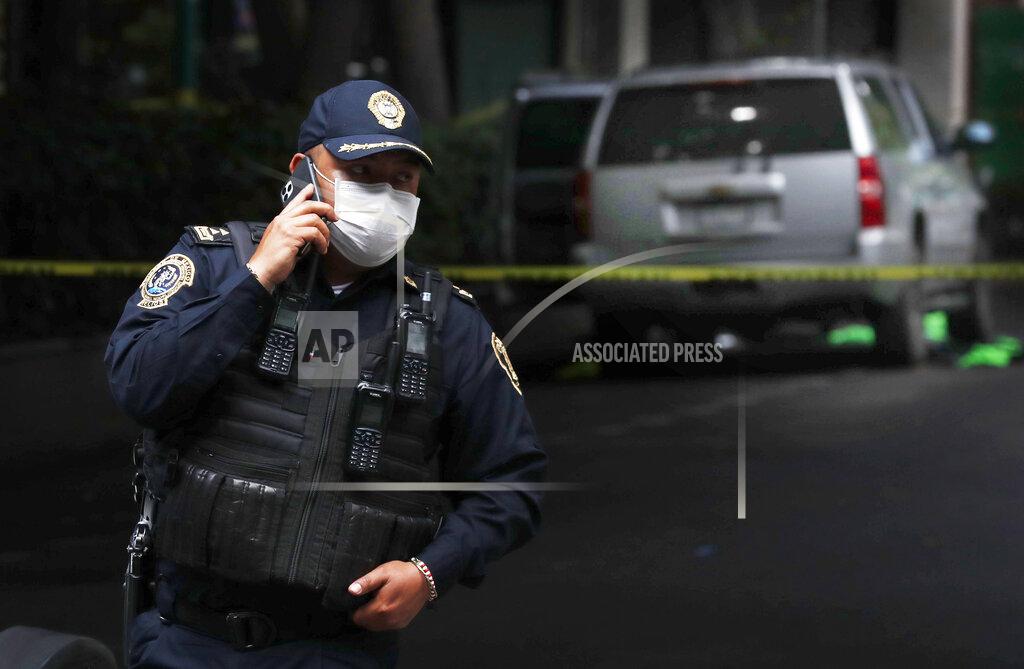 Marco Ugarte An abandoned vehicle that is believed to have been used by gunmen in an attack against the chief of police is sealed off with yellow tape and guarded by police, in Mexico City, Friday, June 26, 2020. Heavily armed gunmen attacked and wounded Omar Garcia Harfuch in a brazen operation that left an unspecified number of dead, Mayor Claudia Sheinbaum said Friday. (AP Photo/Marco Ugarte)