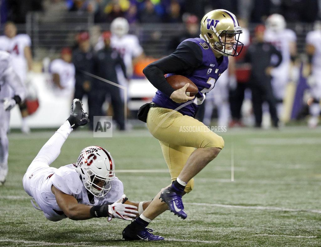 Washington quarterback Jake Browning, right, escapes a tackle attempt by Stanford's Jordan Fox during the second half of an NCAA college football game Saturday, Nov. 3, 2018, in Seattle. Washington won 27-23. (AP Photo/Elaine Thompson)