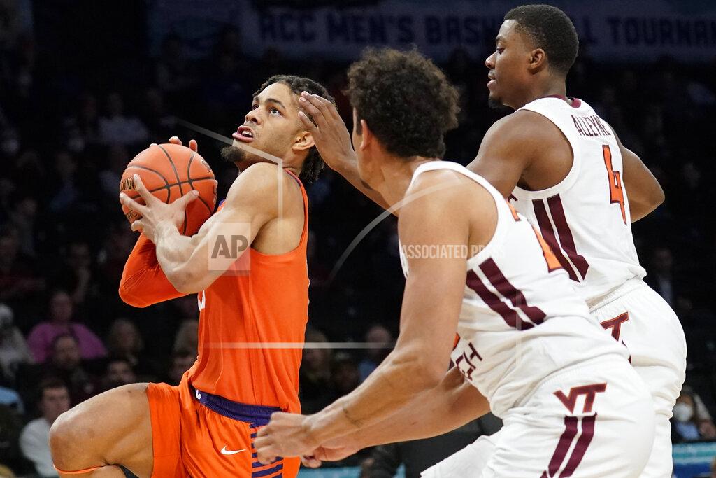 John Minchillo Clemson Tigers' David Collins, left, drives to the net against Virginia Tech's Nahiem Alleyne (4) in the first half of an NCAA college basketball game during the Atlantic Coast Conference men's tournament, Wednesday, March 9, 2022, in New York. (AP Photo/John Minchillo)
