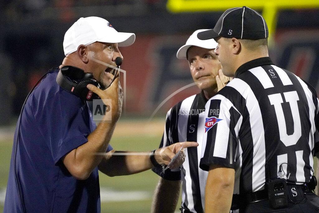 Charles Rex Arbogast UTSA head coach Jeff Taylor, left, talks with the officials during the first half of an NCAA college football game against Illinois, Saturday, Sept. 4, 2021, in Champaign, Ill. (AP Photo/Charles Rex Arbogast)