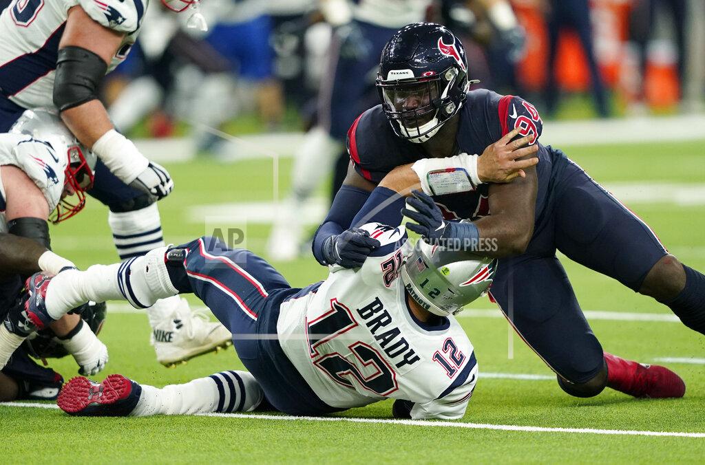 David J. Phillip New England Patriots quarterback Tom Brady (12) is hit by Houston Texans defensive end Charles Omenihu (94) after releasing a pass during the first half of an NFL football game Sunday, Dec. 1, 2019, in Houston. (AP Photo/David J. Phillip)