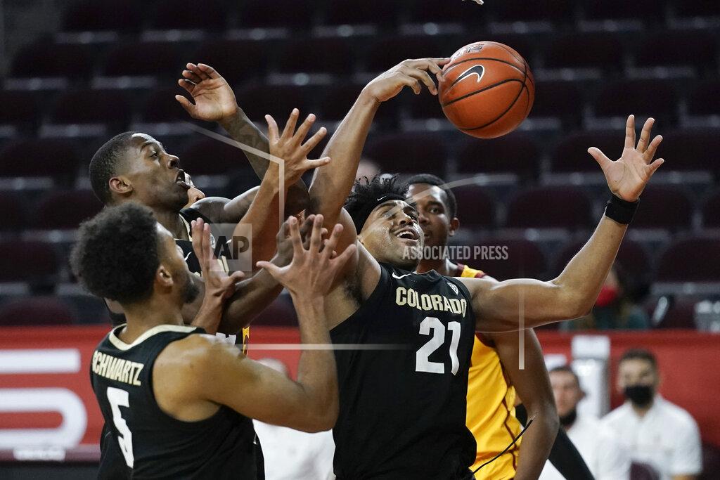 Jae C. Hong Colorado's Evan Battey, center, grabs a rebound during the second half of the team's NCAA college basketball game against Southern California, Thursday, Dec. 31, 2020, in Los Angeles. Colorado won 72-62. (AP Photo/Jae C. Hong)