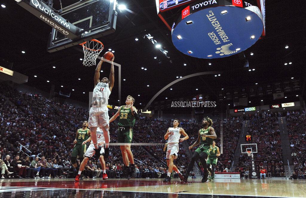 Orlando Ramirez San Diego State forward Matt Mitchell (11) goes to the basket ahead of Cal Poly forward Kyle Colvin (33) during the first half of an NCAA college basketball game Saturday, Dec. 28, 2019, in San Diego. (AP Photo/Orlando Ramirez)