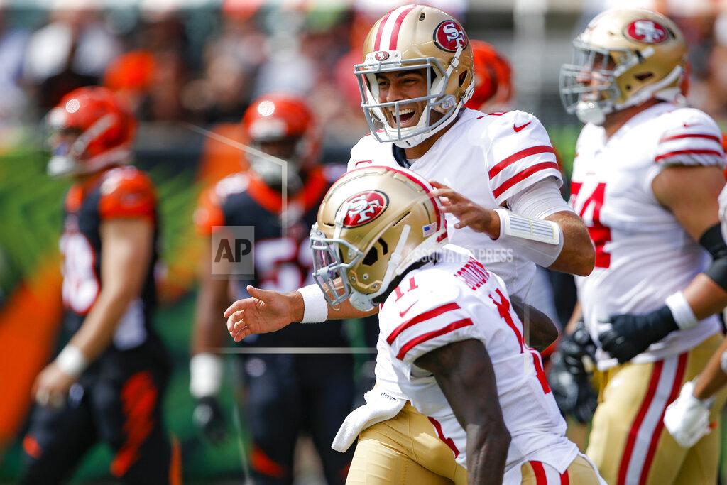 Gary Landers San Francisco 49ers quarterback Jimmy Garoppolo, above, celebrates after wide receiver Marquise Goodwin, below, scores a touchdown during the first half an NFL football game against the Cincinnati Bengals, Sunday, Sept. 15, 2019, in Cincinnati. (AP Photo/Gary Landers)