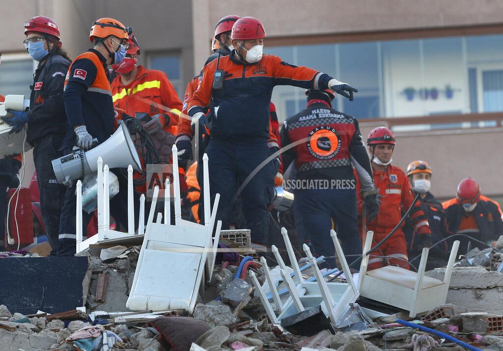Darko Bandic Members of rescue services search for survivors in the debris of a collapsed building in Izmir, Turkey, Saturday, Oct. 31, 2020. Rescue teams on Saturday ploughed through concrete blocs and debris of eight collapsed buildings in Turkey's third largest city in search of survivors of a powerful earthquake that struck Turkey's Aegean coast and north of the Greek island of Samos, killing dozens Hundreds of others were injured. (AP Photo/Darko Bandic)