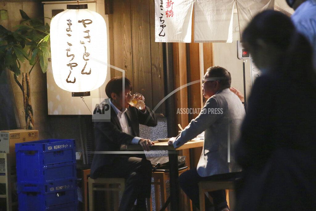 Koji Sasahara FILE - In this Oct. 4, 2021, file photo, people enjoy drinks at a bar following the end of the current coronavirus state of emergency restrictions, in Tokyo. People in Tokyo could eat and drink inside bars and restaurants for longer evening hours starting Monday, Oct. 25, 2021 as officials eased social distancing rules with the country’s daily coronavirus cases reaching its lowest levels in more than a year. (AP Photo/Koji Sasahara, File)
