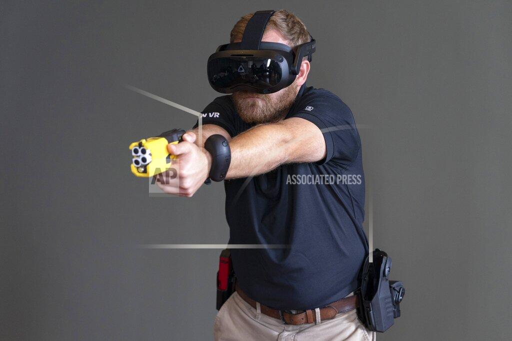 Jacquelyn Martin VR equipment and a version of the TASER 7 that utilizes VR technology for training, is demonstrated, Thursday, May 12, 2022, in Washington. Axon, the company that is best known for developing the Taser, is expanding virtual reality and immersive training in an effort to encourage police officers across the U.S. to more regularly train with less-than-lethal weapons. (AP Photo/Jacquelyn Martin)