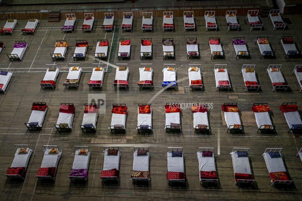 Dar Yasin Beds lie inside an indoor stadium converted into COVID-19 treatment center for emergencies in the wake of the spike in the numbers of positive coronavirus cases in Srinagar, Indian controlled Kashmir, Wednesday, April 28, 2021. India, a country of nearly 1.4 billion people, Wednesday became the fourth nation to cross 200,000 deaths. (AP Photo/ Dar Yasin)
