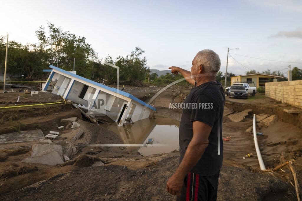 Alejandro Granadillo A man points to a home that was collapsed by Hurricane Fiona at Villa Esperanza in Salinas, Puerto Rico, Wednesday, September 21, 2022. (AP Photo/Alejandro Granadillo)