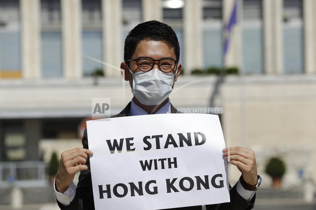 Andrew Medichini FILE - In this Aug. 25, 2020, file photo, Hong Kong activist Nathan Law takes part in a protest during a meeting of Chinese Foreign Minister Wang Yi with Italian Foreign Minister Luigi Di Maio, in Rome. Hong Kong democracy activists have launched a new push to continue their fight among residents living abroad in the wake of a sweeping crackdown by Beijing and changes to the the semi-autonomous Chinese city's electoral system aimed at shutting out opposition voices. (AP Photo/Andrew Medichini, file)